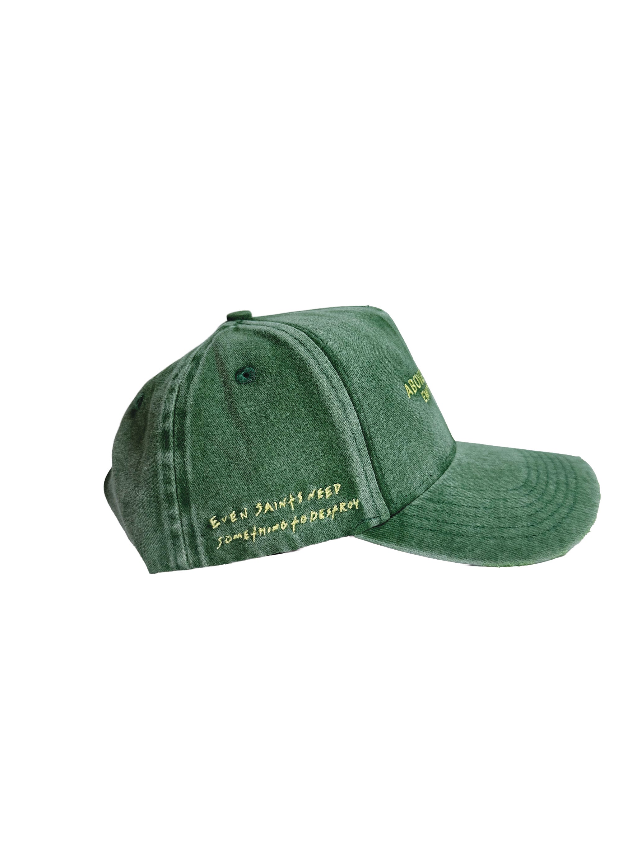 Above All Saints green washed snapback cap with yellow embroidered text reading 'ABOVE ALL SAINTS EMPTY PROPHETS' on the front