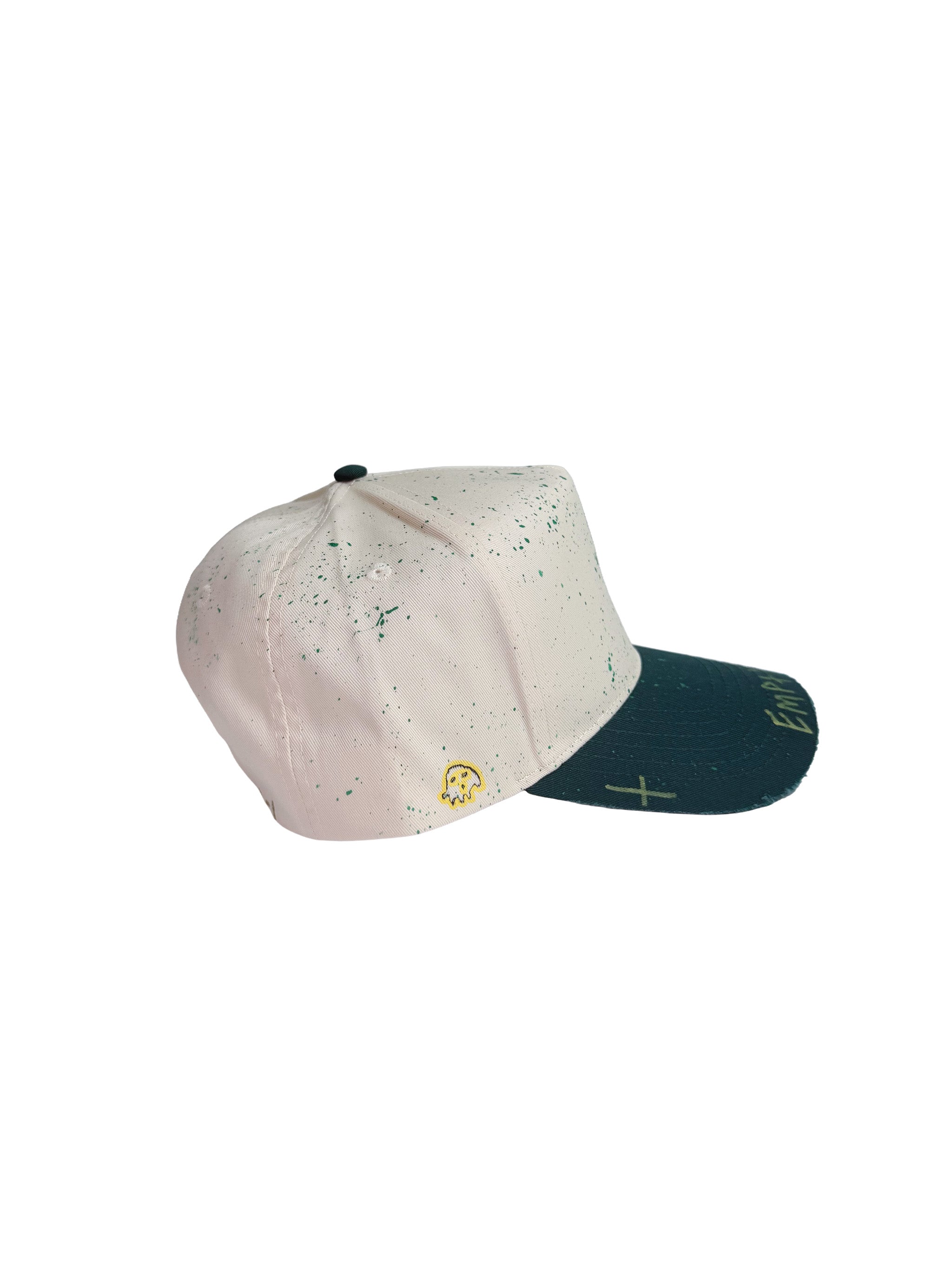 Splattered Green paint throughout the hat, Carolina Blue hand drawn gothic "E" on front. Hand Distressed. 